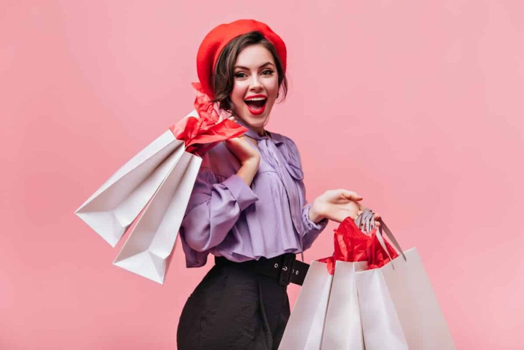 Woman Red Hat Black Trousers Light Blouse Laughs Poses With Packages After Shopping 1 1024x683